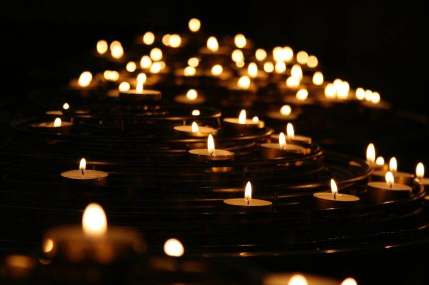 A view of multiples candles lit in the dark indicating the Candlelight- 100 Years of Warner Bros event.