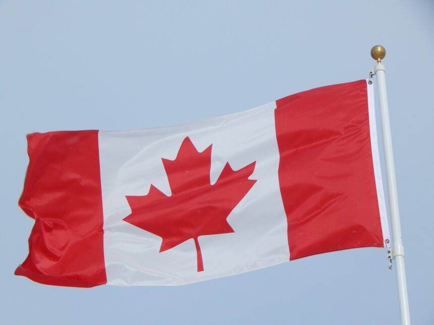 An image of an isolated Canadian flag flaring in the air.