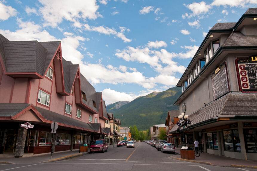 A view of a street with brown buildings around it.