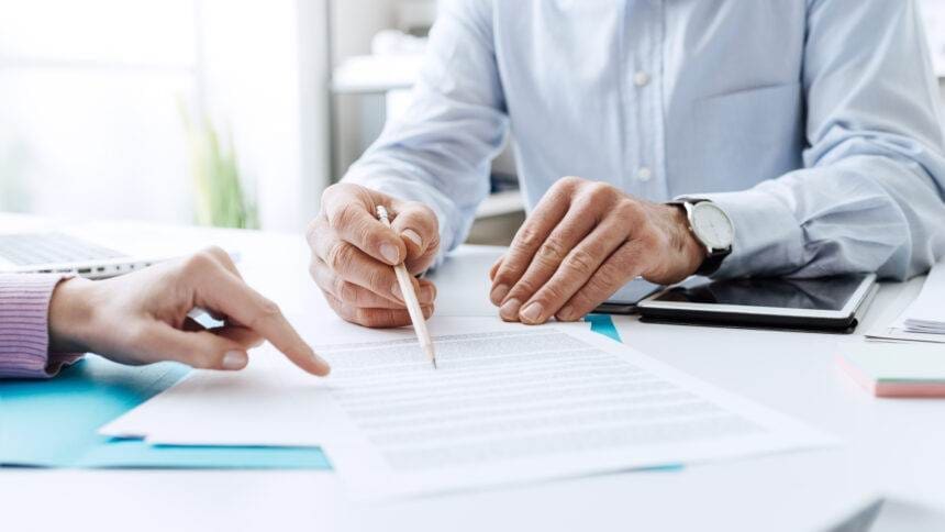 A person discussing with a consultant for understanding contracts.