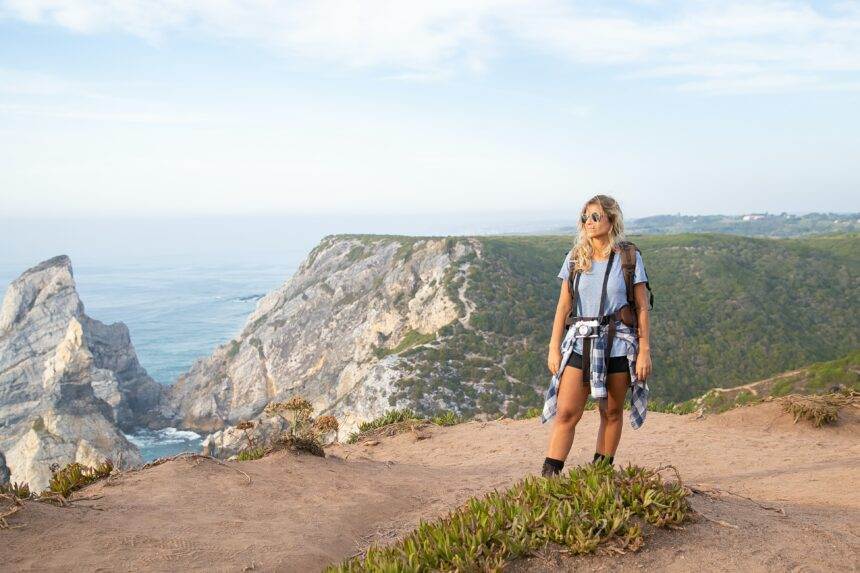 A woman hiking on a path beside mountains in Vancouver.