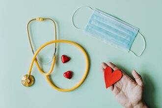 Healthcare equipment is displayed on a plain surface.
