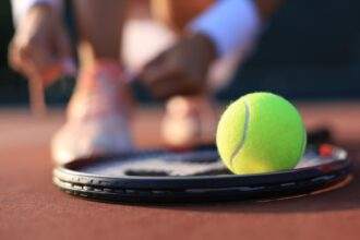 Tennis racket and tennis ball on the court