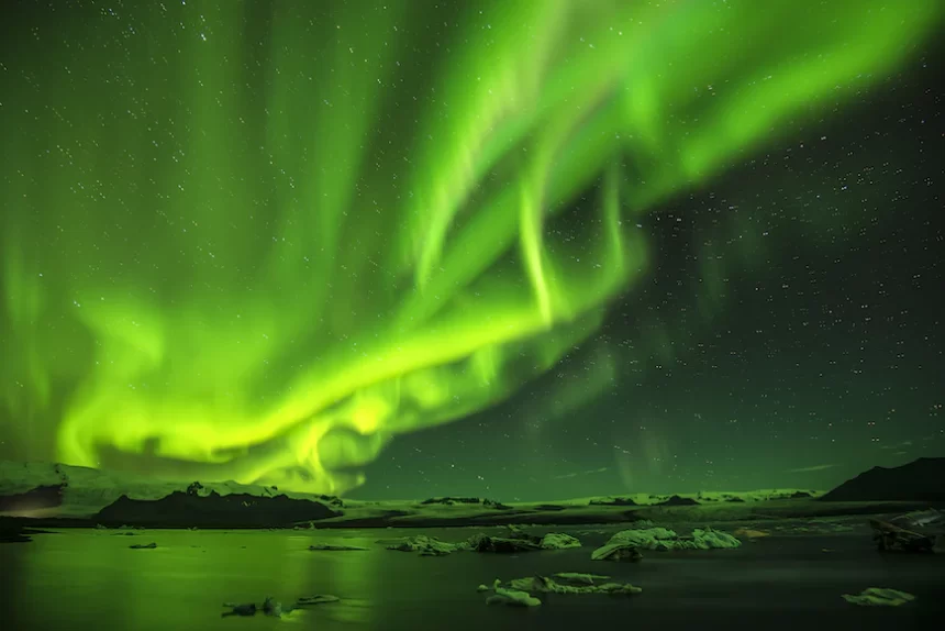 Northern lights above a water body.