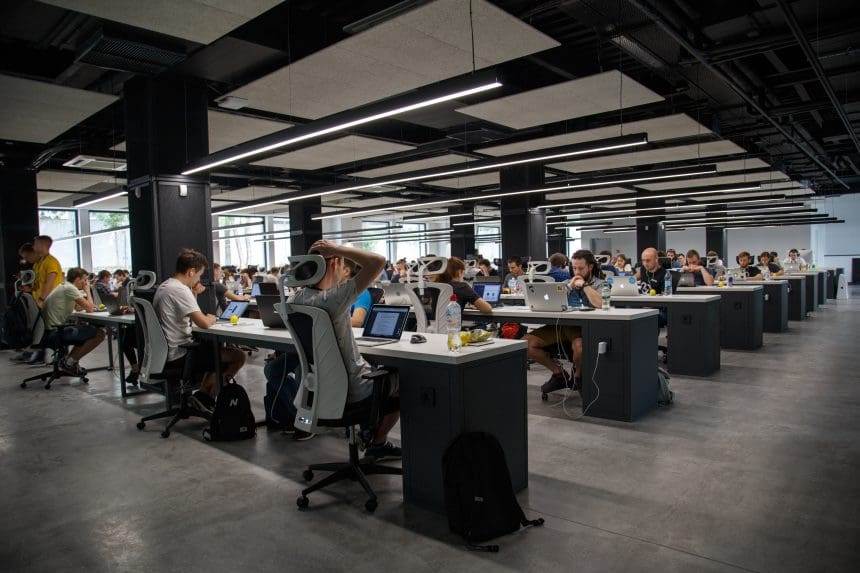 An office area where people are working on their computers.