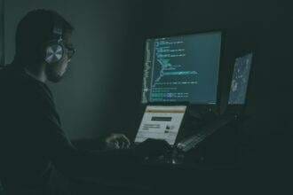 A person working on a computers doing the coding.