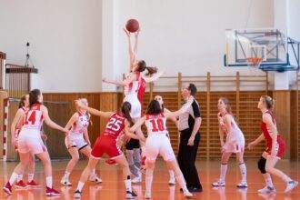 A group of women playing basketball game