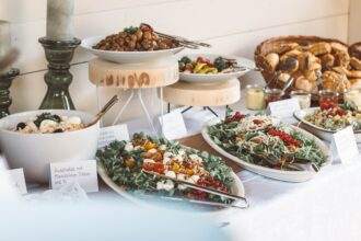 A view of catering service with a variety of food on the table.
