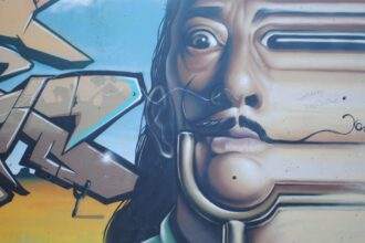 A Salvador Dali graffiti art on a wall.
