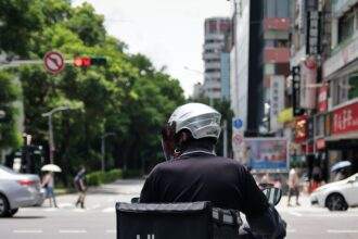 A person on his bike with the Uber Eats Box at the back to deliver the food.