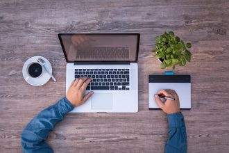 A top view of a person using a laptop for Graphic Designer