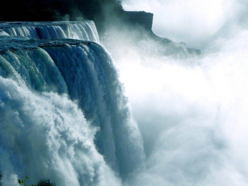 A view of Niagara falls where water falls with force.