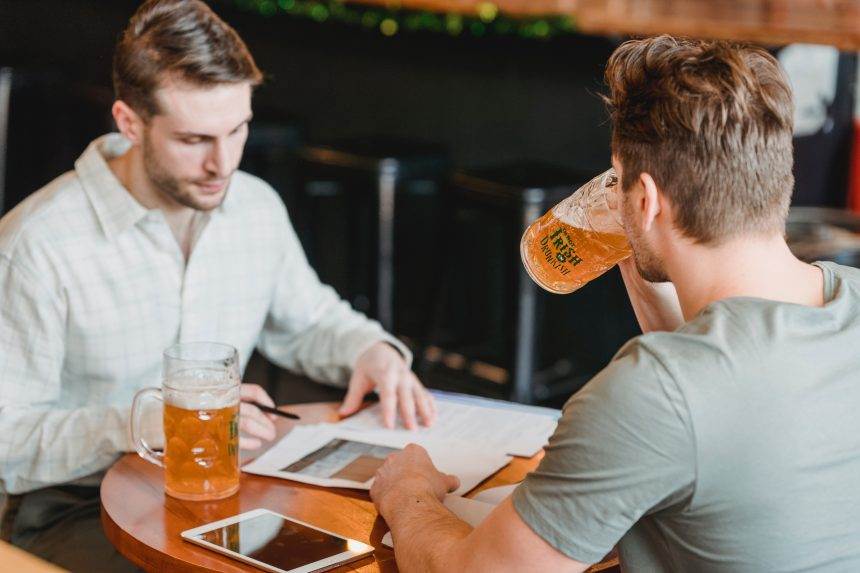 Workers enjoying alcohol in a restaurant.