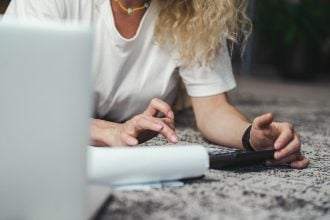 A woman working using a calculator.