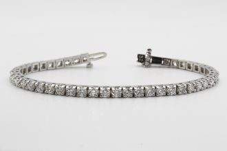 A tennis bracelet on a white background.