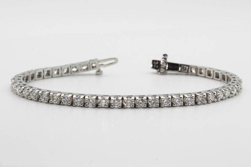 A tennis bracelet on a white background.