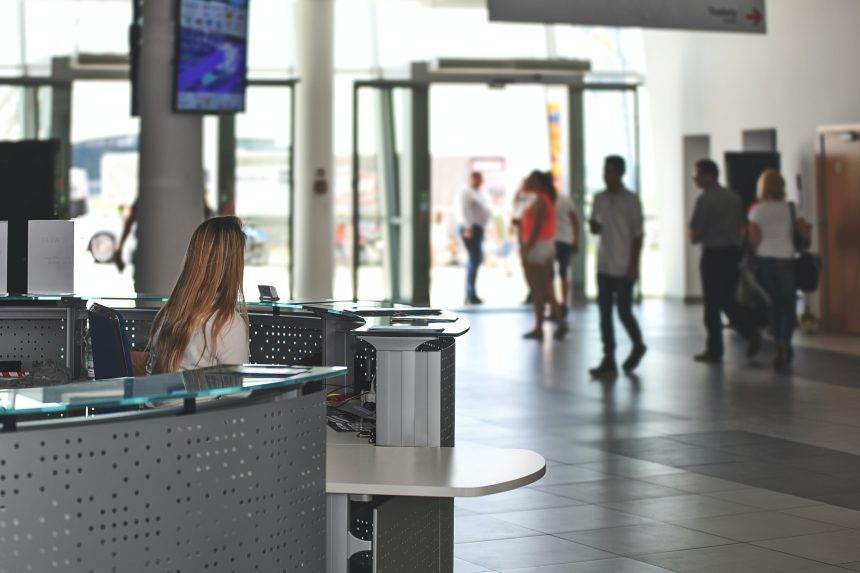 White sitting behind the reception desk