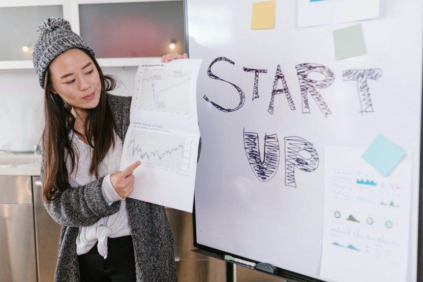 Woman holding white paper with graphics