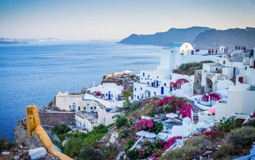 Scenic view of Santorinis white buildings and blue waters.