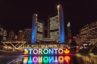 Toronto cityscape at night with illuminated buildings and reflection