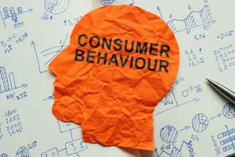 Crumpled paper with Consumer Behaviour on marketing analysis chart.