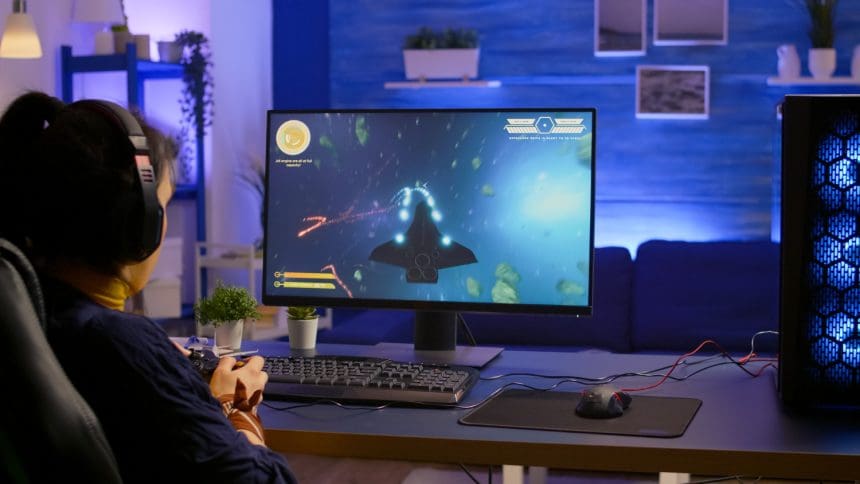 Gamer engaged in online space shooter game competition.