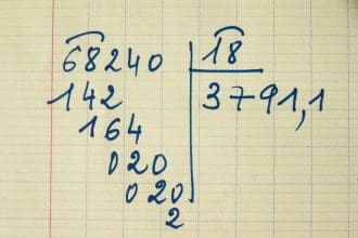 Long division method on lined paper.