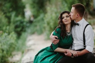 Romantic couple sharing a tender moment outdoors.