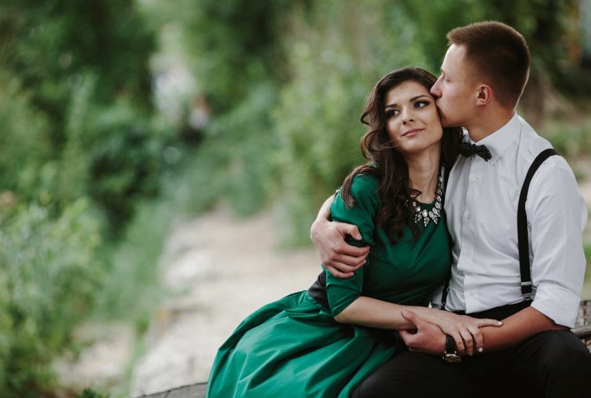 Romantic couple sharing a tender moment outdoors.